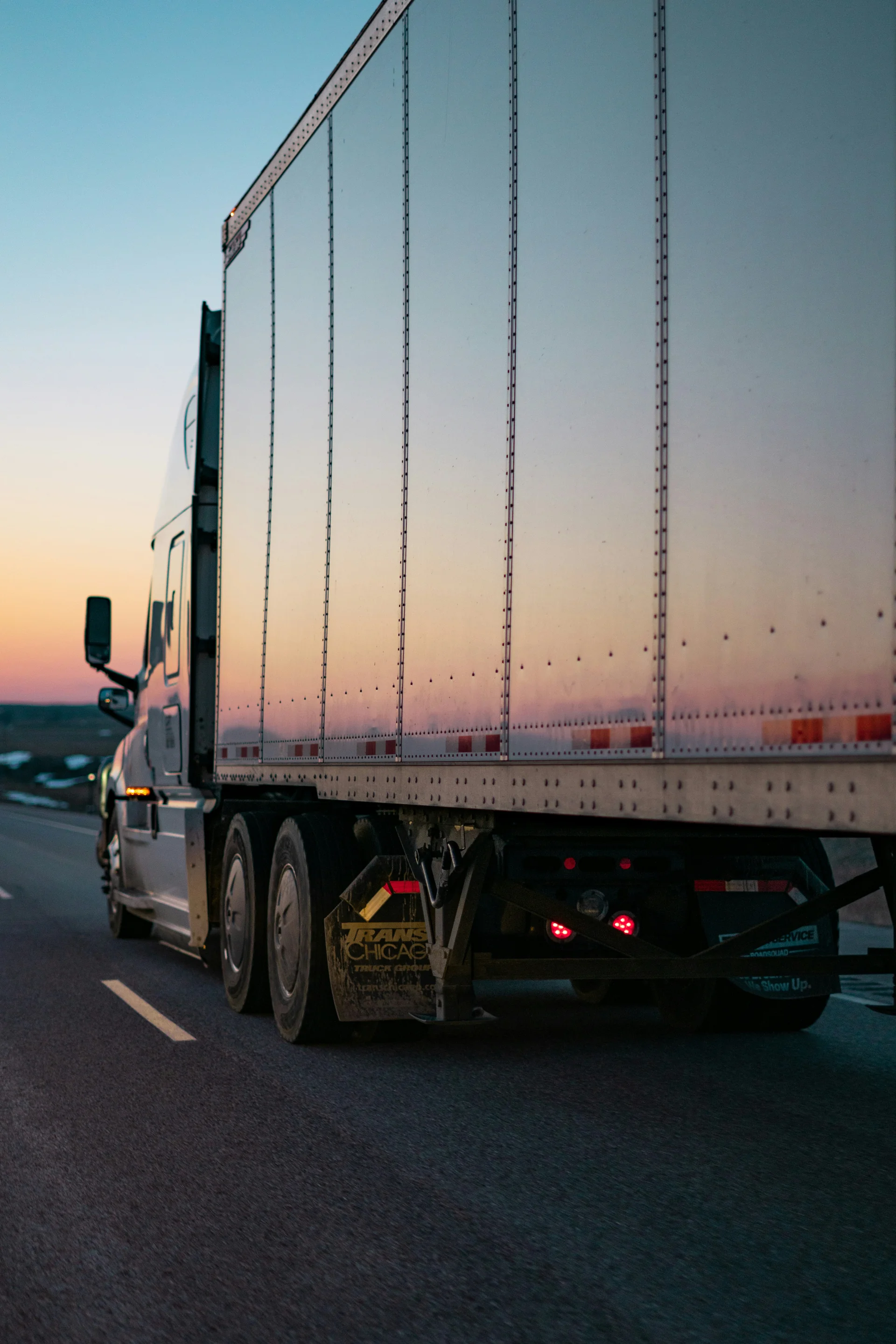 A trailer on the road at sunset